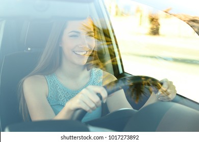 Portrait Of A Happy Attentive Driver Woman Driving A Car On The Road