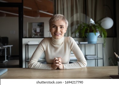 Portrait Of Happy Attractive Young Businesswoman With Short Haircut Sitting At Table, Looking At Camera. Web Cam View Skilled Female Worker Holding Video Call Meeting With Partners Or Client From