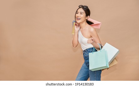 Portrait Of Happy Beautiful Shopaholic Asian Woman Carry Shopping Bags, Summer Fashion Sale Model Asia Girl With Copy Space, Outlet Department Store Advertising Concept Isolated Banner Background