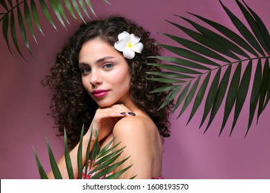 Portrait Of Happy Beautiful Woman With Long Bouncy Curls Hairstyle And Professional Make Up On, Posing Over Isolated Purple Background. Fashion Shot Of Young Gorgeous Female. Close Up, Copy Space.