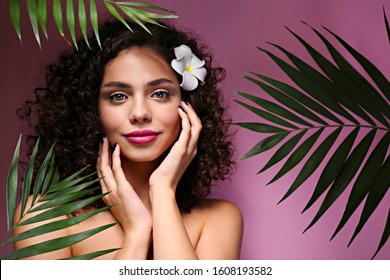 Portrait Of Happy Beautiful Woman With Long Bouncy Curls Hairstyle And Professional Make Up On, Posing Over Isolated Purple Background. Fashion Shot Of Young Gorgeous Female. Close Up, Copy Space.