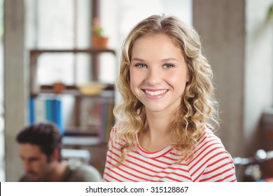 Portrait of happy beautiful woman standing in creative bright office - Shutterstock ID 315128867