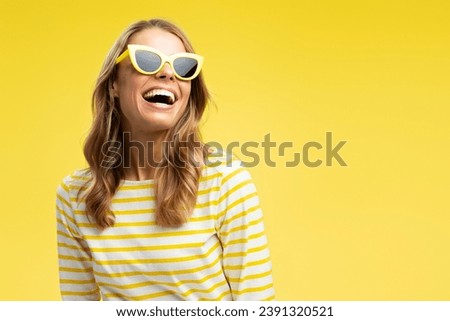 Portrait happy beautiful woman with stylish hair wearing sunglass looking away isolated on yellow background, copy space. Fashion model posing for pictures in studio. Advertisement, summer, travel