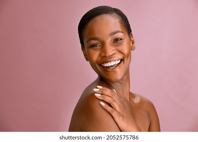 Portrait Of Happy Beauty African American Woman Touching Her Perfect Smooth Skin Isolated On Pink Background With Copy Space. Carefree Mature Black Lady Laughing After Spa Anti-aging Treatment.