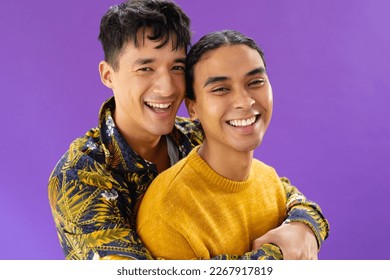 Portrait of happy biracial couple embracing and smiling on purple background. Lgbt and pride concept. - Powered by Shutterstock