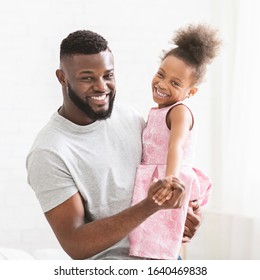 Portrait Of Happy Black Dad And Daughter In Beautiful Dress Dancing Together At Home