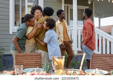 Portrait Of Happy Black Family Embracing While Enjoying Summer Party Outdoors, Copy Space