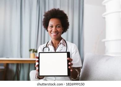 Portrait Of Happy Black Healthcare Worker Holding Digital Tablet And Looking At Camera.