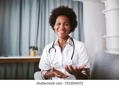 Portrait of happy black healthcare worker gesturing with hands looking at camera.
