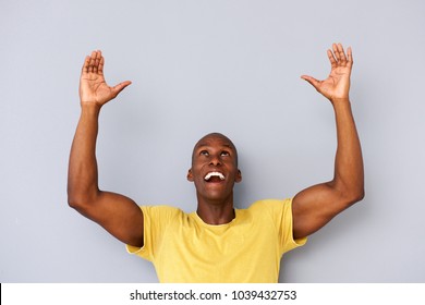 Portrait Of Happy Black Man With Arms And Hands Raised To Lift