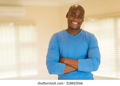 Portrait Of Happy Black Man With Arms Folded