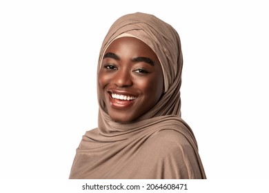 Portrait Of Happy Black Muslim Lady In Hijab Laughing, Looking And Posing At Camera, Standing Isolated Over White Studio Background, Empty Space. African American Lady In Headscarf Smiling