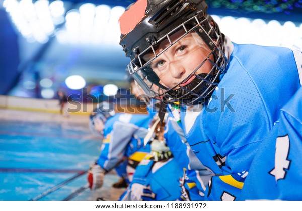 Portrait of happy boy\
in ice hockey uniform