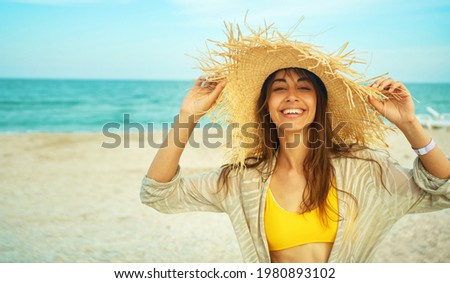 portrait happy bright summer woman with beautiful smile in big straw hat at beach
