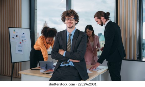 Portrait of happy Business looking camera and people converse during a meeting about papers and concepts. - Shutterstock ID 2232962081