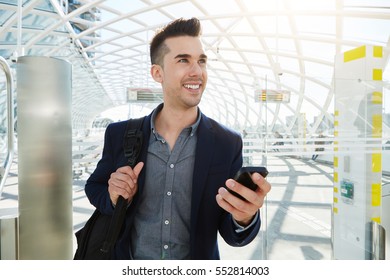 Portrait Of Happy Business Man In Station With Mobile Phone