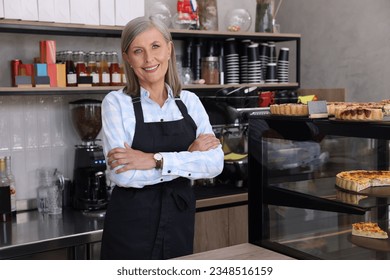 Portrait of happy business owner in her cafe - Powered by Shutterstock