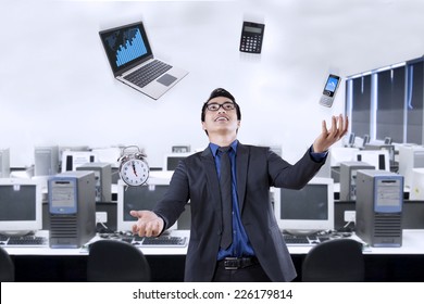 Portrait Of Happy Businessman Juggling With Business Items In The Office