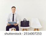 Portrait of a happy businessman waiting job interview in the office. Prospective candidate, exudes confidence and positivity, ready to showcase skills and contribute to the business, work environment.