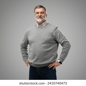 Portrait of happy casual mature man smiling, senior age man with gray hair, Isolated on gray background, copy space - Powered by Shutterstock