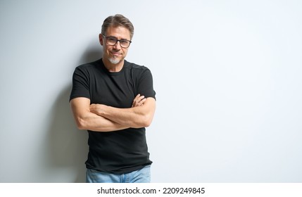 Portrait Of Happy Casual Older Man In Glasses Smiling, Mid Adult, Mature Age Guy At White Wall, Isolated On White Background, Copy Space.