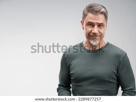 Portrait of happy casual older man smiling, Mid adult, mature age guy standing, isolated on gray background.
