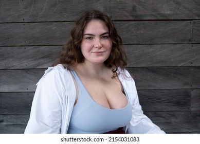 Portrait happy caucasian attractive overweight girl in white shirt looking at camera