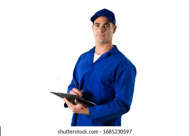 Portrait Of A Happy Caucasian Male Engineer Car Mechanic With Short Dark Hair Standing Holding A Clipboard And Pen, Wearing Work Clothes And Cap, Looking At Camera Smiling On White Background