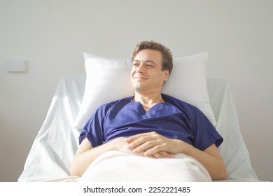 Portrait of happy caucasian sick patient on bed in hospital in medical and healthcare treatment at nursing home or clinic. People lifestyle - Powered by Shutterstock