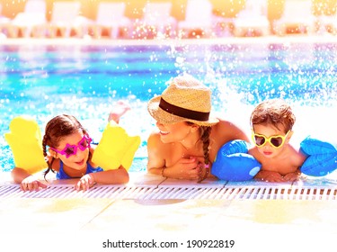 Portrait Of Happy Cheerful Family Having Fun In Aquapark, Swimming In The Pool, Relaxing In Luxury Summer Resort, Holidays And Vacation Concept