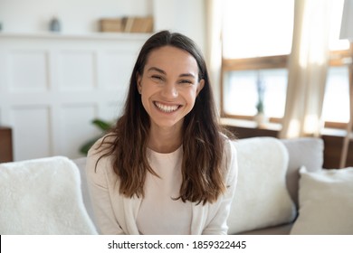 Portrait of happy cheerful millennial female renter tenant owner of new apartment flat, smiling young woman vlogger looking at camera broadcasting recording new video content for subscribers followers - Shutterstock ID 1859322445