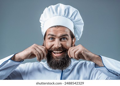 Portrait of a happy chef cook. Bearded man in chef uniform. Professional happy man chef ready to cook new dish. Male chef, cook or baker in white hat and apron. - Powered by Shutterstock