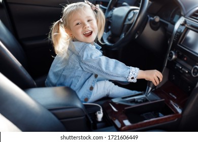 Portrait Of A Happy Child Driving A Car