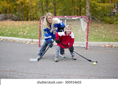 A portrait of happy child play hockey outside