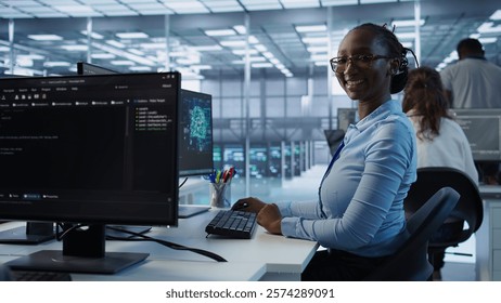 Portrait of happy computer scientist programming in AI data center used for machine learning training. Joyful IT professional working on artificial intelligence tech in server hub office, camera B