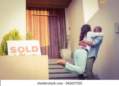 Portrait Of Happy Couple After Buying New House