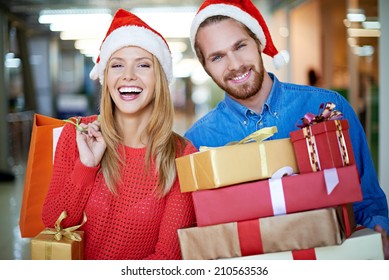 Portrait of happy couple with Christmas presents - Powered by Shutterstock