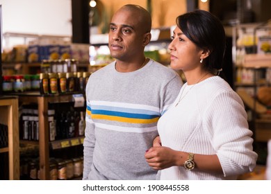 Portrait of happy couple in grocery supermarket interior