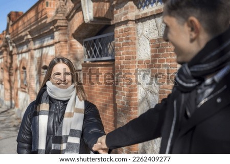 Similar – Image, Stock Photo Twin sisters take pictures of each other with smartphone at a bridge railing