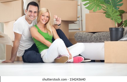 Portrait of happy couple with key of new home