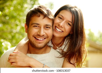 Portrait Of A Happy Couple Laughing At Camera