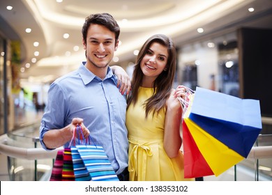 Portrait Of Happy Couple With Shopping Bags 