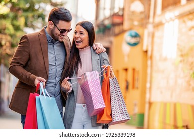 Portrait of happy couple with shopping bags.People,sale,consumerism and lifestyle concept.
