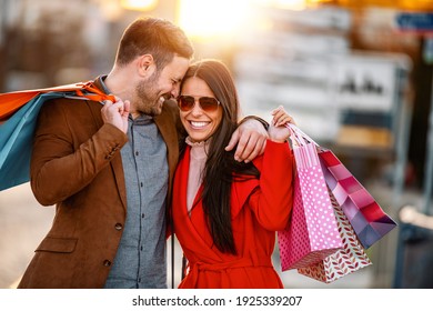 Portrait of happy couple with shopping bags.People,sale,consumerism and lifestyle concept. - Powered by Shutterstock