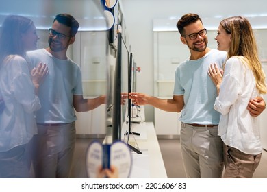 Portrait Of Happy Couple Shopping In A Tech Store. Technology People Smart Device Concept