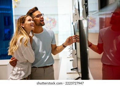 Portrait Of Happy Couple Shopping In A Tech Store. Technology People Smart Device Concept