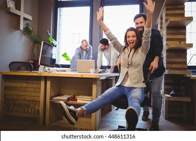 Portrait Of Happy Coworkers Enjoying In Creative Office