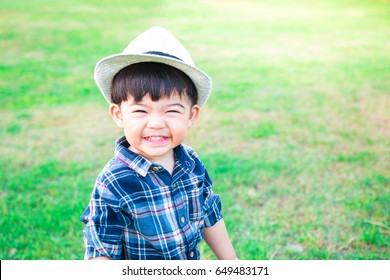 Portrait happy cute child having fun in the garden. Standing in the grass. Smiling
 
