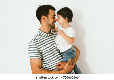 Portrait Of Happy Dad And Daughter Play And Cuddle Together Against White Background. Good Relationship Of Parent And Child. Happy Family Moments Of Father And Toddler Girl. Childhood And Parenthood.