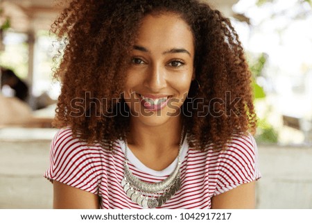 Similar – blYoung black woman, afro hairstyle, smiling outdoors